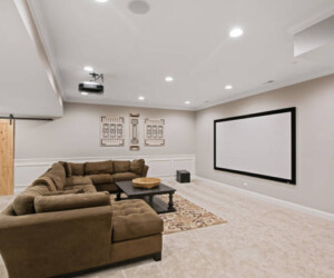 Projector screen and comfortable seating in spacious basement room